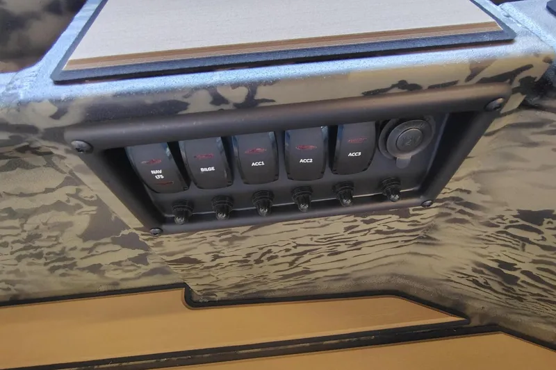 Slide: The Image of Control panel of 2026 Tracker Grizzly 1756 T Marsh boat with camouflage design. - 7