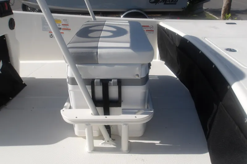 Slide: The Image of 2026 Mako Pro Skiff 17 CC boat interior with cushioned seating and storage. - 14