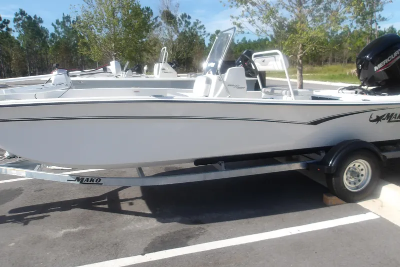 The Image of 2026 Mako Pro Skiff 17 CC boat on trailer, parked outdoors. - 1