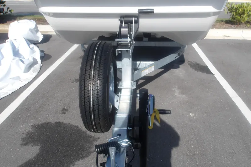 Slide: The Image of Front view of a 2026 Mako Pro Skiff 17 CC boat on a trailer in a parking lot. - 4