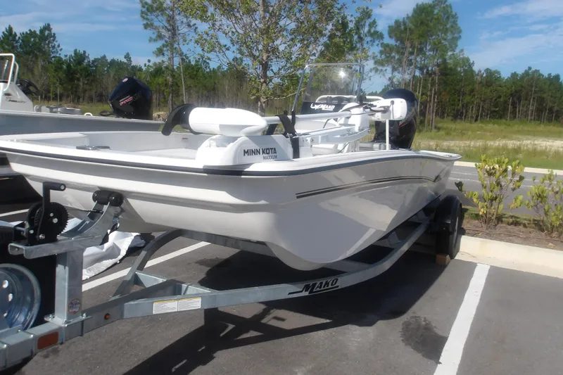 Slide: The Image of 2026 Mako Pro Skiff 17 CC boat on trailer, featuring Minn Kota motor, parked outdoors. - 3