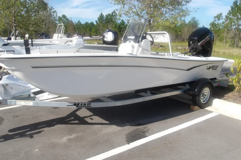 Slide: The Image of 2026 Mako Pro Skiff 17 CC boat on trailer, parked outdoors. - 2