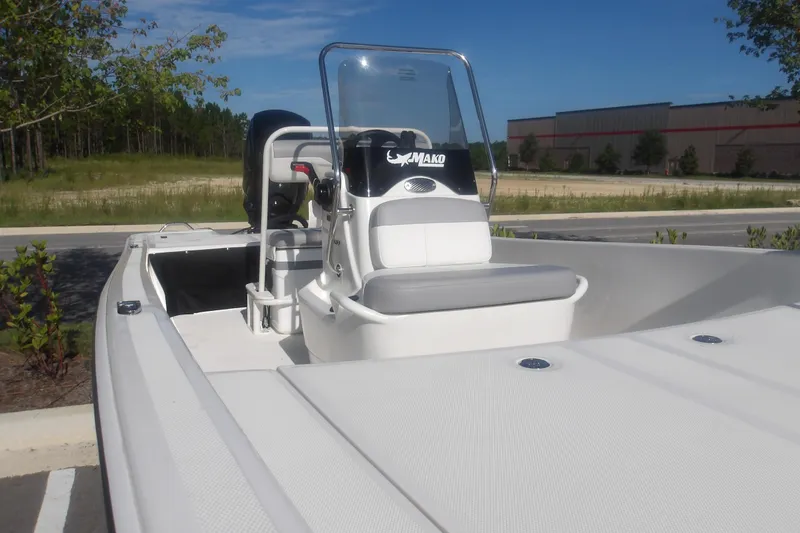 Slide: The Image of 2026 Mako Pro Skiff 17 CC boat with center console in a parking lot. - 6