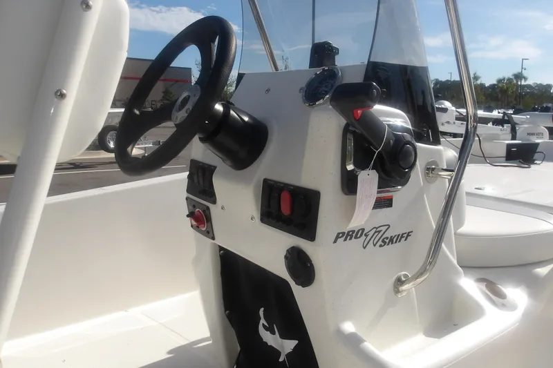 Slide: The Image of 2026 Mako Pro Skiff 17 CC boat console with steering wheel and controls. - 11