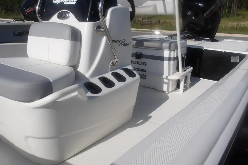 Slide: The Image of 2026 Mako Pro Skiff 17 CC interior with seating and storage features. - 12