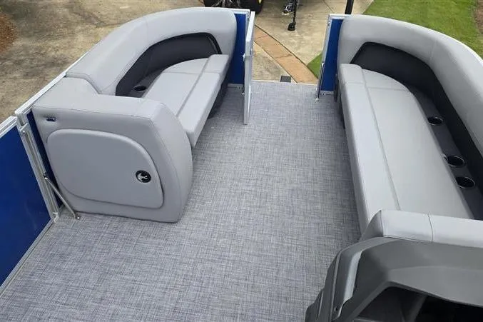 Slide: The Image of 2026 Sun Tracker Party Barge 18 DLX interior with gray seating and carpeted floor. - 9