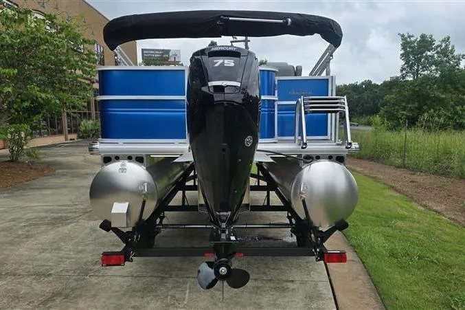 Slide: The Image of 2026 Sun Tracker Party Barge 18 DLX pontoon boat with Mercury 75 engine, parked outdoors. - 3