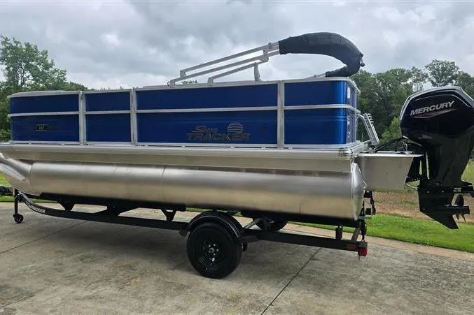 Slide: The Image of 2026 Sun Tracker Party Barge 18 DLX pontoon boat with Mercury outboard motor on trailer. - 4