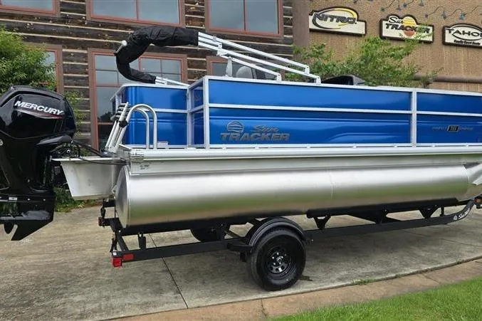 Slide: The Image of 2026 Sun Tracker Party Barge 18 DLX pontoon boat with Mercury engine on trailer. - 5