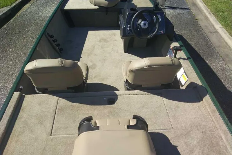 Slide: The Image of 2026 Tracker Bass Tracker Classic Limited boat interior with beige seats and steering console. - 20