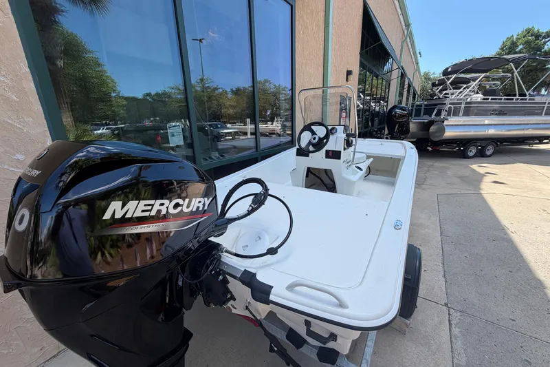 Slide: The Image of 2026 Mako Pro Skiff 13 CC with Mercury engine displayed outdoors. - 3