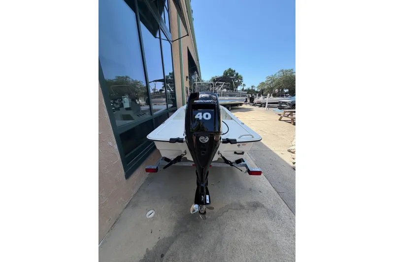 Slide: The Image of 2026 Mako Pro Skiff 13 CC with Mercury 40 engine, parked outdoors. - 7