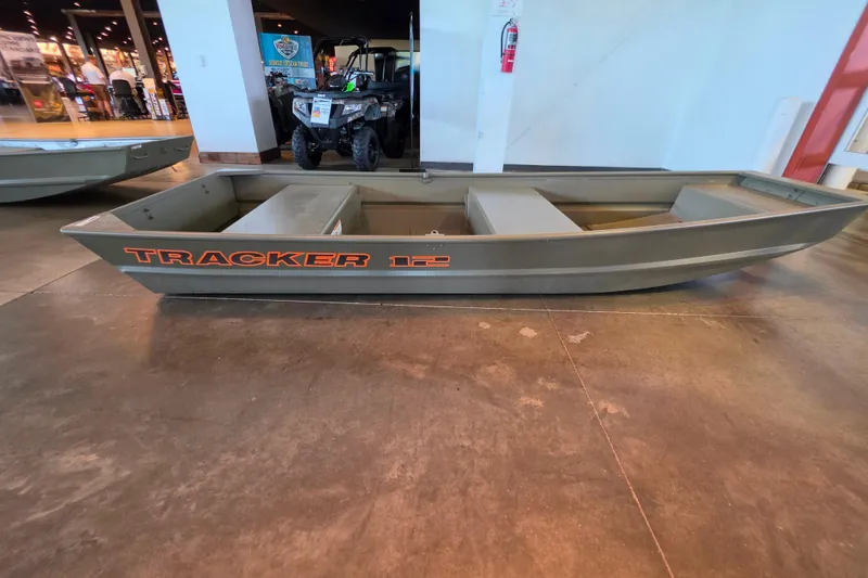 The Image of 2026 Tracker Grizzly 12 Jon boat displayed indoors on concrete floor. - 0