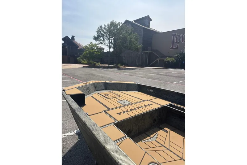 Slide: The Image of 2026 Tracker Grizzly 1756 T Marsh boat in parking lot, sunny day. - 4