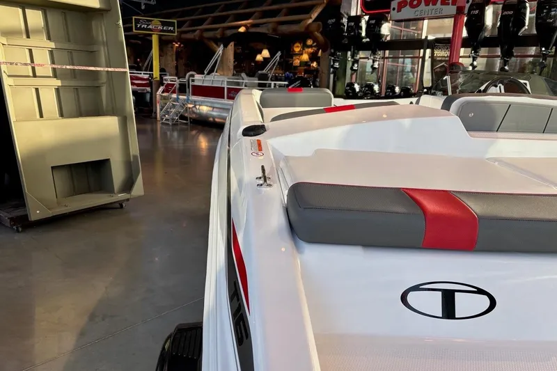 Slide: The Image of 2026 Tahoe T16 boat interior with red and gray seating in showroom. - 9