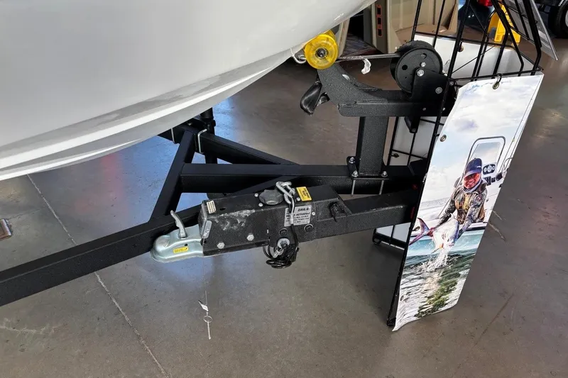 Slide: The Image of Trailer hitch of a 2026 Tahoe T16 boat in a showroom setting. - 5