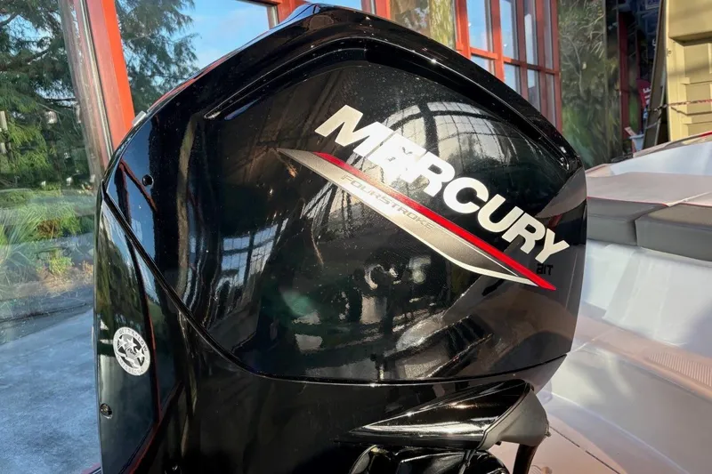 Slide: The Image of Mercury outboard motor on 2026 Tahoe T16 boat, displayed indoors. - 14