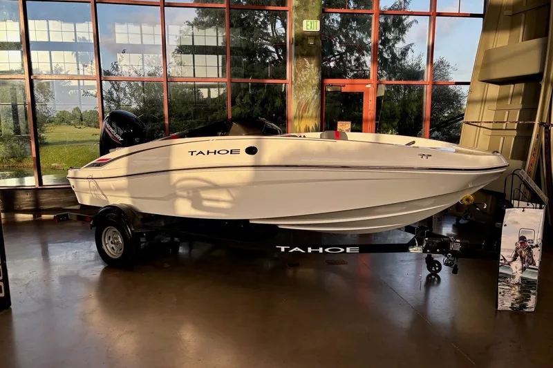 Slide: The Image of 2026 Tahoe T16 boat displayed indoors with scenic window view. - 2