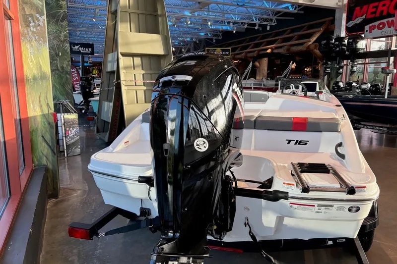 Slide: The Image of 2026 Tahoe T16 boat with Mercury outboard motor displayed in showroom. - 16