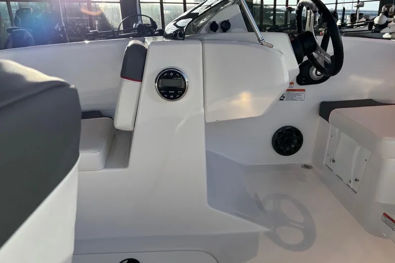 Slide: The Image of 2026 Tahoe T16 boat interior with steering wheel and seating, showcasing modern design. - 13