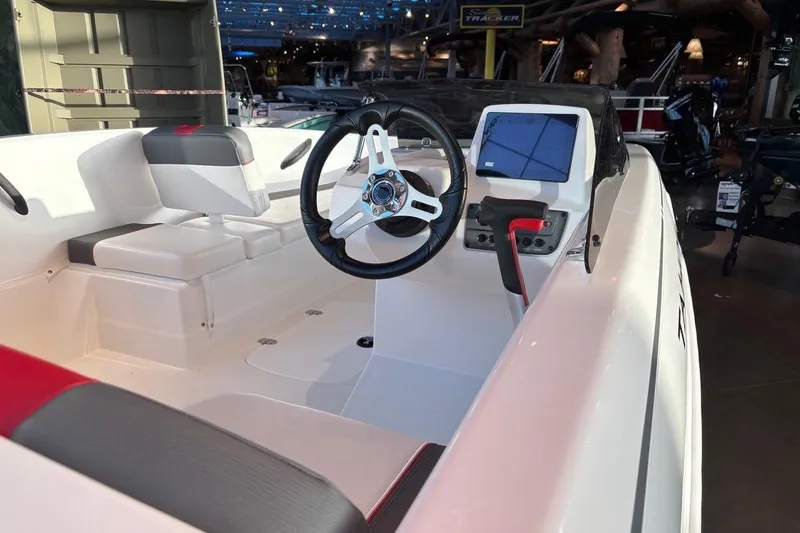 Slide: The Image of 2026 Tahoe T16 boat interior with modern steering wheel and dashboard controls. - 6