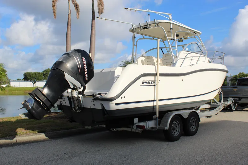 Slide: The Image of 2005 Boston Whaler 255 Conquest boat on trailer with Mercury outboard engine. - 23