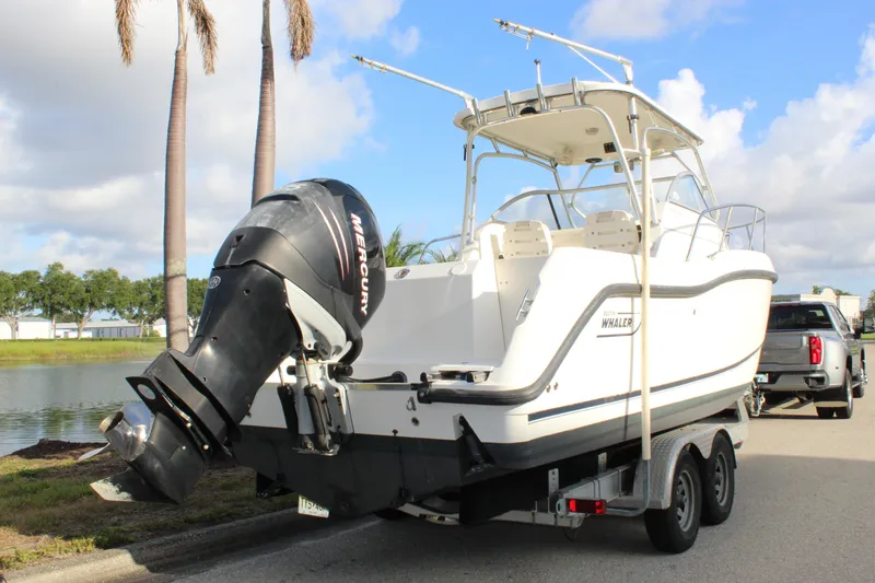 Slide: The Image of 2005 Boston Whaler 255 Conquest boat on trailer with Mercury outboard motor. - 24