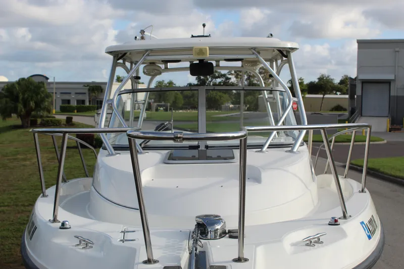 Slide: The Image of 2005 Boston Whaler 255 Conquest boat, docked outdoors, showcasing bow and railings. - 25