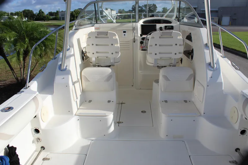 Slide: The Image of 2005 Boston Whaler 255 Conquest boat interior with dual seats and steering console. - 31