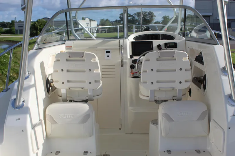 Slide: The Image of 2005 Boston Whaler 255 Conquest boat cockpit with dual seats and steering console. - 33