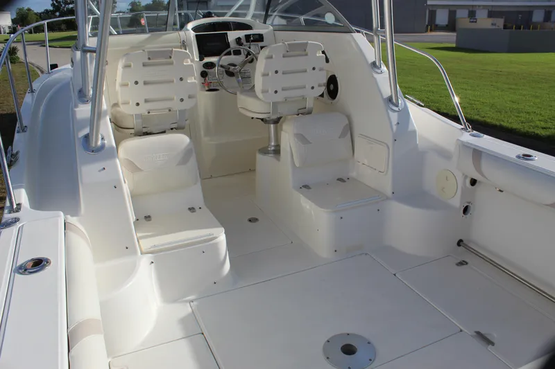 Slide: The Image of 2005 Boston Whaler 255 Conquest boat interior with helm and seating area. - 35