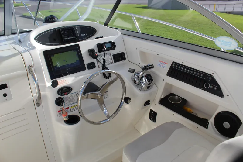 Slide: The Image of Helm of 2005 Boston Whaler 255 Conquest with steering wheel and navigation controls. - 36