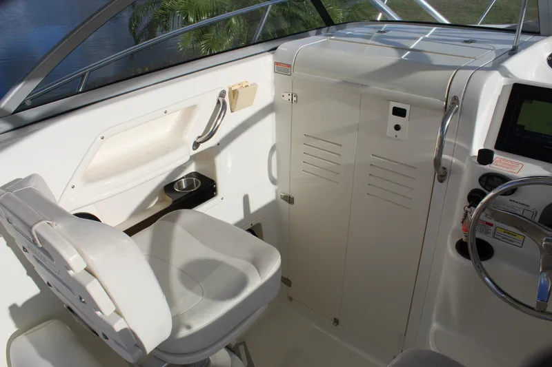 Slide: The Image of Interior of a 2005 Boston Whaler 255 Conquest boat, featuring helm and seating area. - 38