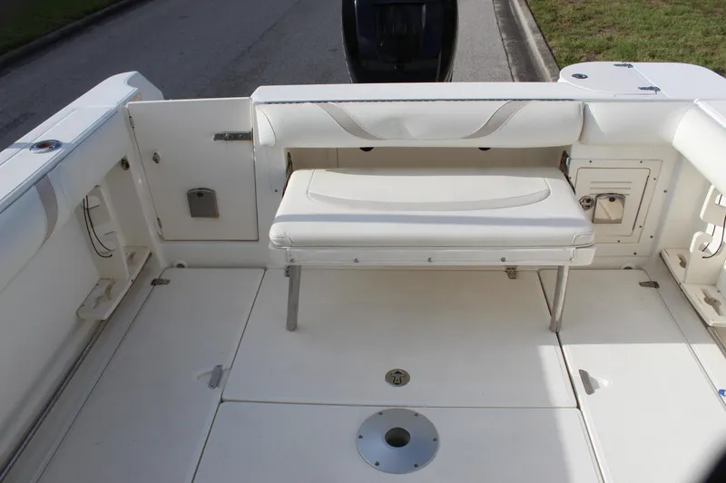 Slide: The Image of 2005 Boston Whaler 255 Conquest boat interior with foldable seating and storage compartments. - 40