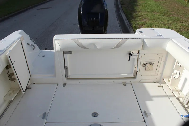 Slide: The Image of 2005 Boston Whaler 255 Conquest boat deck with storage compartments and seating. - 41