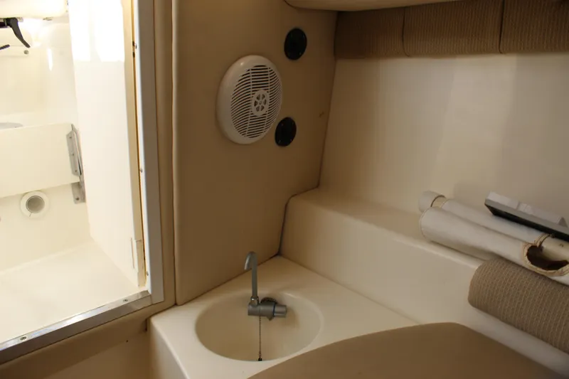Slide: The Image of Interior cabin of 2005 Boston Whaler 255 Conquest with sink and speaker. - 44