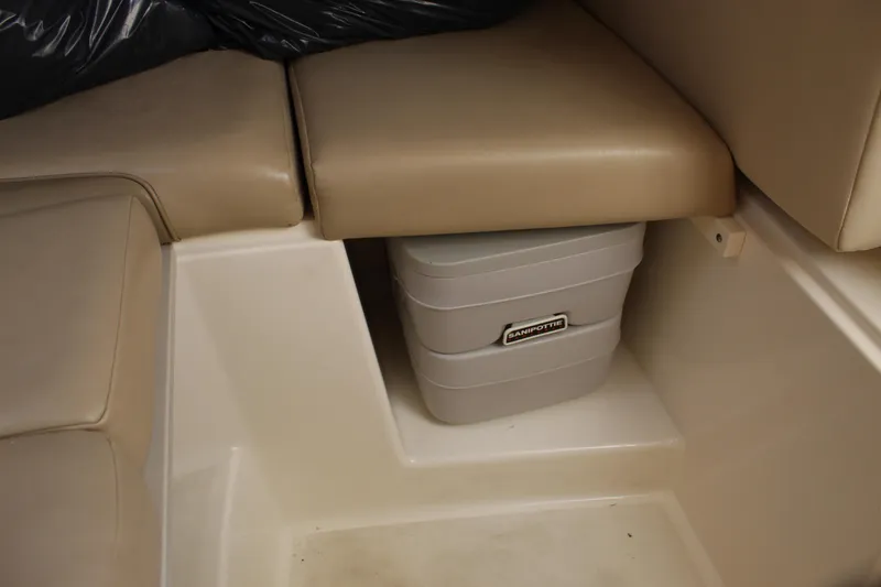 Slide: The Image of Interior of 2005 Boston Whaler 255 Conquest with storage compartment and portable toilet. - 46