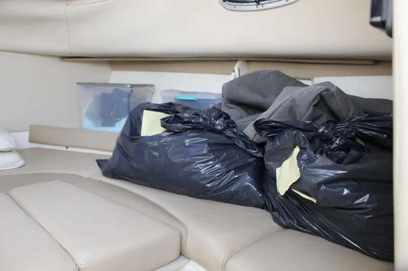 Slide: The Image of Interior cabin of a 2005 Boston Whaler 255 Conquest with storage bags and containers. - 47