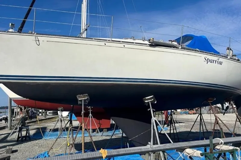 The Image of 1982 C&C 34 sailboat "Sparrow" on dry dock, under clear blue sky. - 1