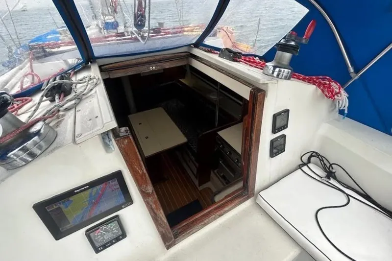 Slide: The Image of Interior view of a 1982 C&C 34 sailboat cockpit with navigation equipment. - 15