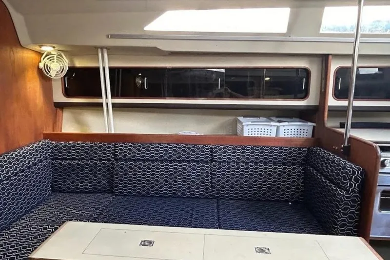 Slide: The Image of Interior of a 1982 C&C 34 sailboat with patterned seating and wooden accents. - 17