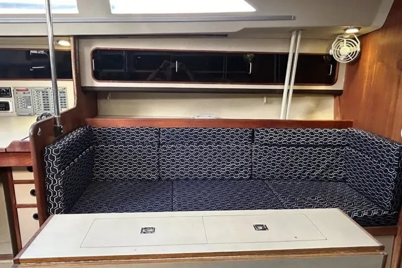 Slide: The Image of Interior of 1982 C&C 34 sailboat with patterned seating and wooden accents. - 18