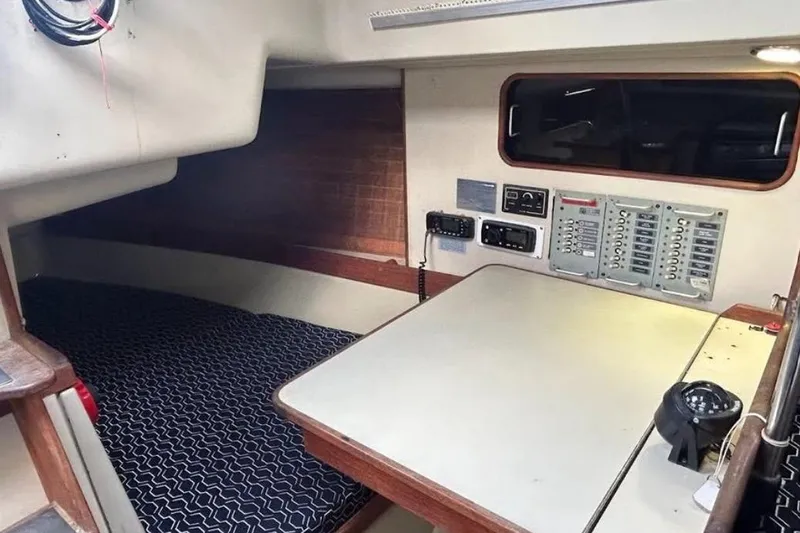 Slide: The Image of Interior of a 1982 C&C 34 sailboat featuring a navigation station and sleeping berth. - 21