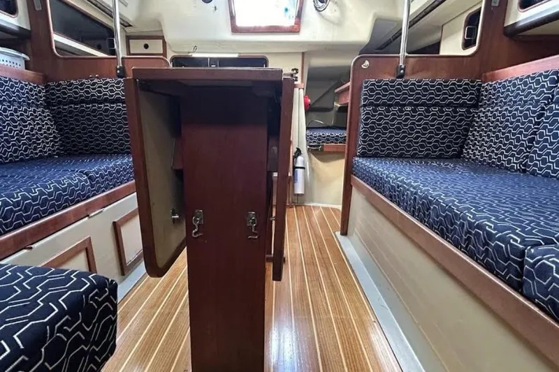 Slide: The Image of Interior of 1982 C&C 34 sailboat with patterned seating and wooden flooring. - 22