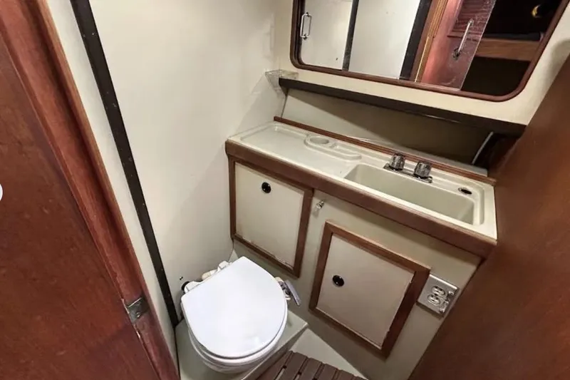 Slide: The Image of 1982 C&C 34 yacht bathroom with sink, mirror, and toilet. - 23