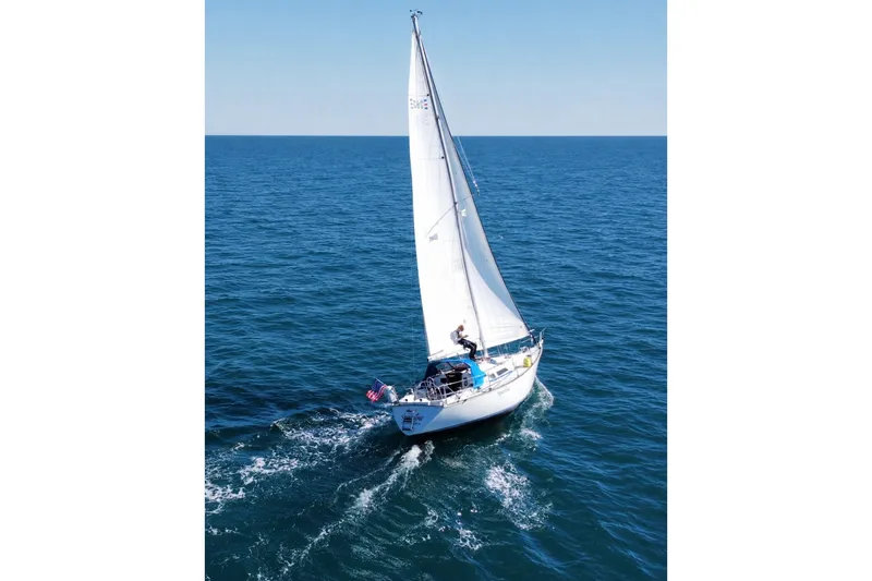The Image of Sailing yacht C&C 34 (1982) cruising on open blue sea under clear sky. - 0