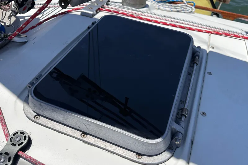 Slide: The Image of Hatch on 1982 C&C 34 sailboat deck with ropes and fittings. - 8
