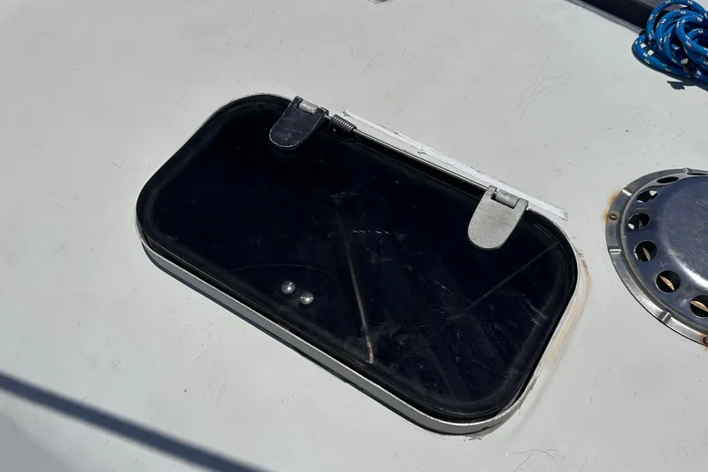 Slide: The Image of Hatch on 1982 C&C 34 sailboat deck with blue rope and metal vent. - 9