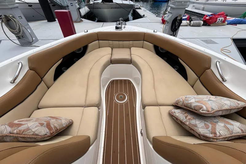 Slide: The Image of Luxurious interior of a 2015 Sea Ray 300 SLX boat with tan seating and decorative pillows. - 7