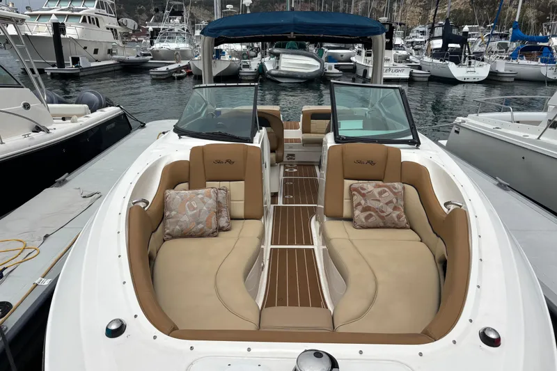Slide: The Image of 2015 Sea Ray 300 SLX boat with tan seating, docked in a marina. - 8